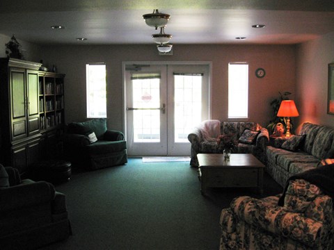 a living room with couches and chairs and a table